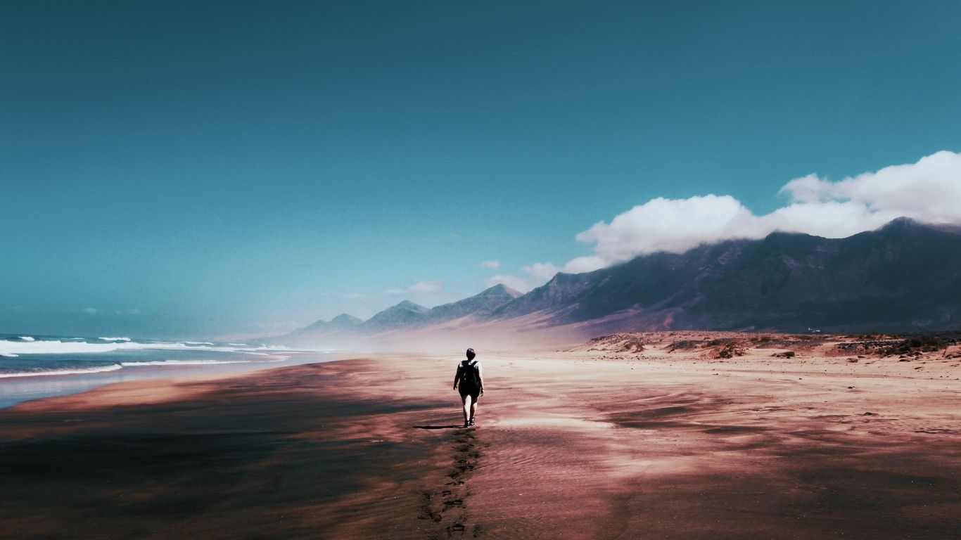 image of person walking on a deserted island